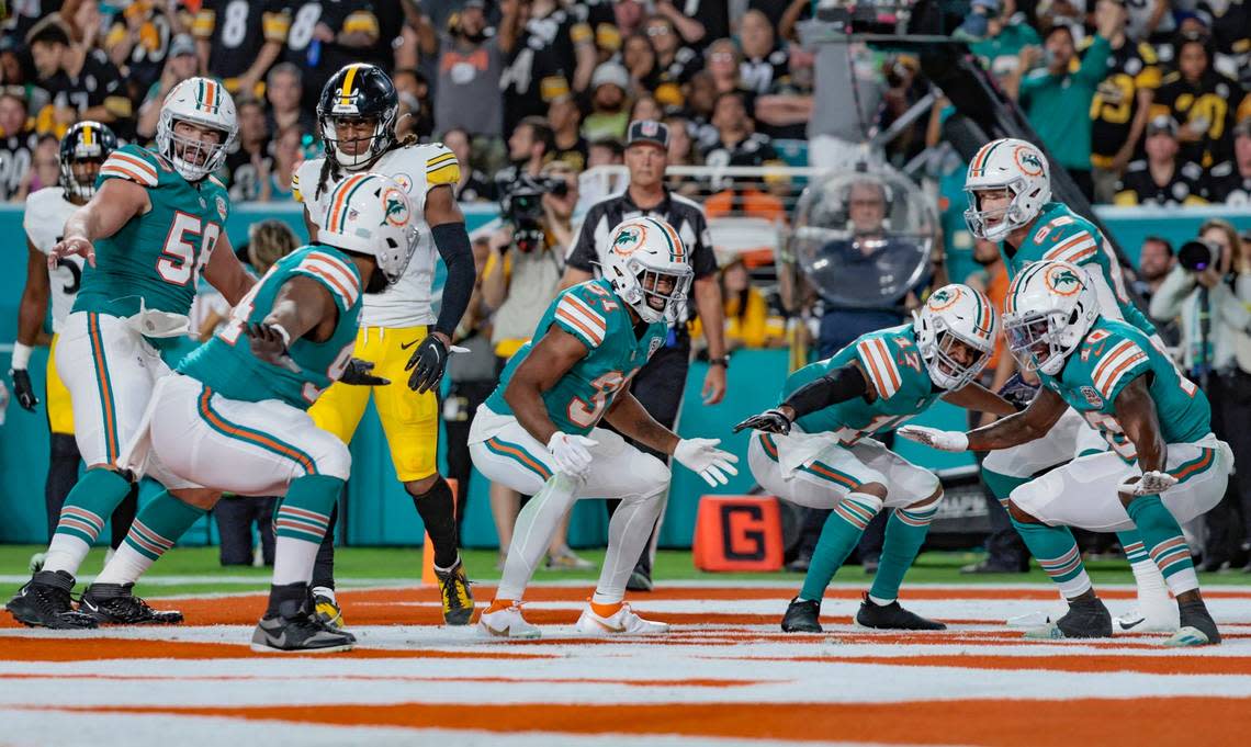 Miami Dolphins running back Raheem Mostert (31) celebrates with teammates after scoring in the first quarter against the Pittsburgh Steelers at Hard Rock Stadium in Miami Gardens on Sunday, October 23, 2022.
