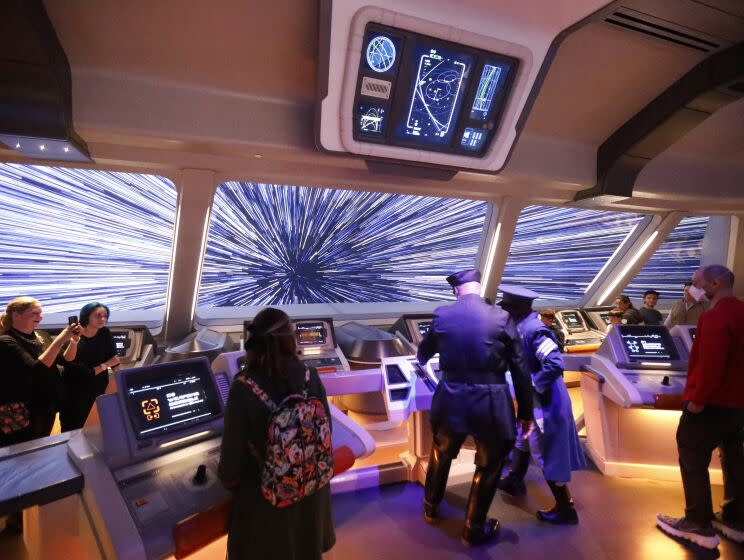 Orlando, Fla - March 01: A First Order loyalist takes control of the ship from captain Riyola Keevan, right center, at the ship's bridge as the first passengers experience the two-day Walt Disney World Star Wars Galactic Starcruiser, which is a live action role playing game that doubles as a high-end hotel in Orlando, Fla. The event is billed as Halcyon's 275th anniversary voyage across the galaxy. at Walt Disney World Star Wars Galactic Starcruiser in Orlando, Fla on Tuesday, March 1, 2022. First Order lieutenant Harman Croy and his garrison of stormtroopers patrol the ship. Guests arrive at Batuu, a destination for a planet excursion. Players use a data pad to play the immersive game while they participate in activities such as light saber training. (Allen J. Schaben / Los Angeles Times)