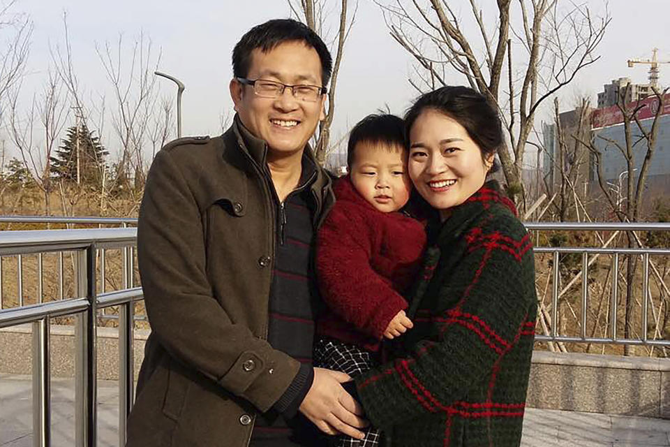 In this Feb. 2015, photo released by Li Wenzu, Wang Quanzhang, left, and his wife Li Wenzu poses for a photo with their son at a park in eastern China's Shandong province. About two dozen plainclothes police are stationed Wednesday Dec. 26, 2018, outside a courthouse in northern China as the trial of Wang, a prominent human rights lawyer was expected to unfold. Wang is among more than 200 lawyers and legal activists who were detained in a sweeping 2015 crackdown. The advocate for the banned Falun Gong meditation sect was charged with subversion of state power in 2016. He has been held without access to his lawyers or family for more than three years. (Wang Quanxiu via AP)