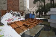 An advertisement board which was toppled over by Typhoon Usagi is pictured in Hong Kong September 23, 2013. A powerful typhoon hit Hong Kong and the southern China coast on Monday, killing at least 20 people on the mainland, crippling power lines and causing flooding and gale force winds.REUTERS/Tyrone Siu