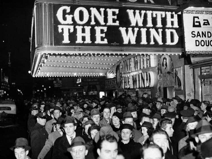 In this Dec. 19, 1939 file photo, a crowd walks past the Astor Theater during the Broadway premiere of "Gone With the Wind" in New York. A Memphis, Tennessee, theater has cancelled an annual screening of the classic 1939 film because of racially insensitive content.