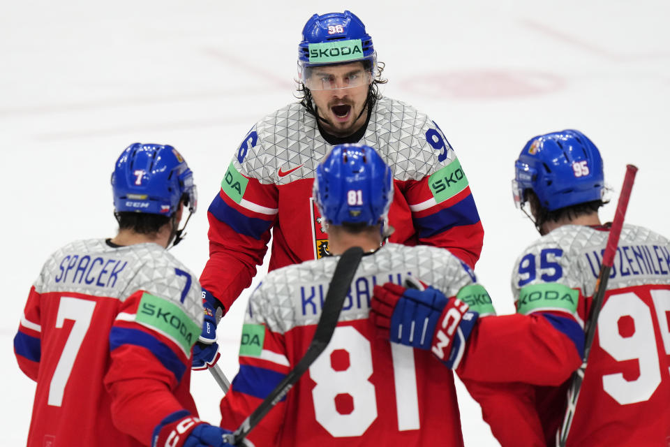 Czech Republic's Dominik Kubalik, center down, celebrates with Czech Republic's David Tomasek, up, and other teammates after scoring his sides second goal during the preliminary round match between Czech Republic and Austria at the Ice Hockey World Championships in Prague, Czech Republic, Friday, May 17, 2024. (AP Photo/Petr David Josek)