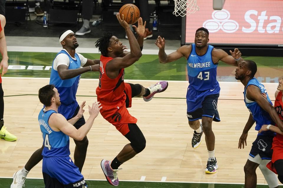Toronto Raptors' OG Anunoby shoots in traffic during the second half of an NBA basketball game against the Milwaukee Bucks Thursday, Feb. 18, 2021, in Milwaukee. (AP Photo/Morry Gash)
