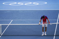 Novak Djokovic, of Serbia, reacts after being defeated by Pablo Carreno Busta, of Spain, in the bronze medal match of the tennis competition at the 2020 Summer Olympics, Saturday, July 31, 2021, in Tokyo, Japan. (AP Photo/Seth Wenig)