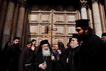 Greek Orthodox Patriarch of Jerusalem, Theophilos III stands with other church leaders after a news conference in front of the closed doors of the Church of the Holy Sepulchre in Jerusalem's Old City, February 25, 2018. REUTERS/Amir Cohen
