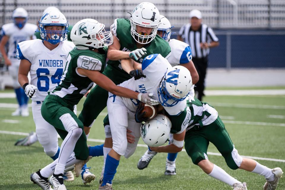 A trio of Fairfield defenders converge to make the tackle on a Windber Area ball carrier during play in the Chambersburg Peach Bowl football showcase on Saturday, August 27, 2022. The Knights fell, 57-0.