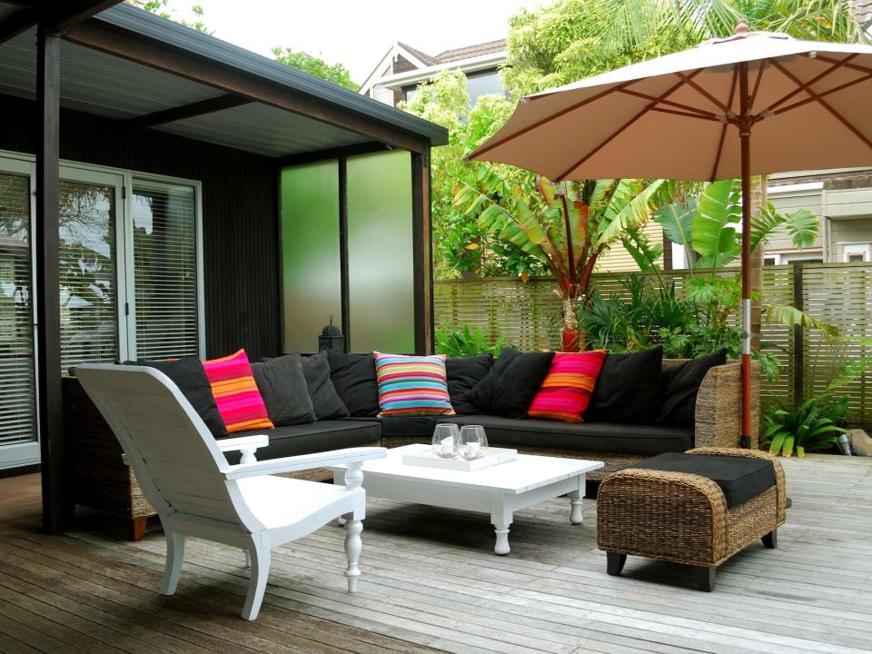 mismatched furniture on an outdoor deck