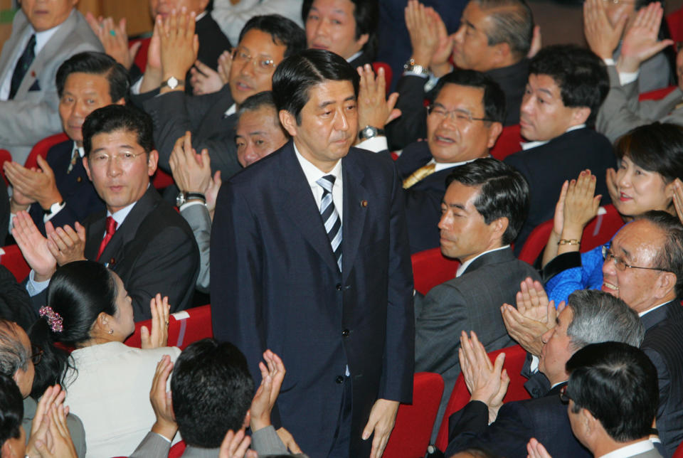 FILE - Shinzo Abe acknowledges applause from the Liberal Democratic Party (LDP) lawmakers as he won a landslide victory Wednesday, Sept. 20, 2006 in Japan's ruling party presidential vote at the LDP headquarters in Tokyo. Former Japanese Prime Minister Abe, a divisive arch-conservative and one of his nation's most powerful and influential figures, has died after being shot during a campaign speech Friday, July 8, 2022, in western Japan, hospital officials said. (AP Photo/Koji Sasahara, File)