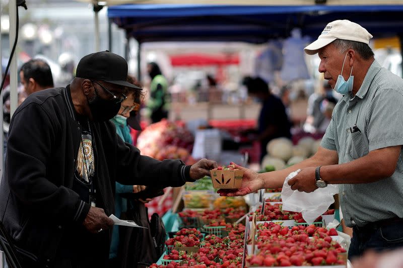 A resident buys strawberries at a local market, in downtown San Francisco, California