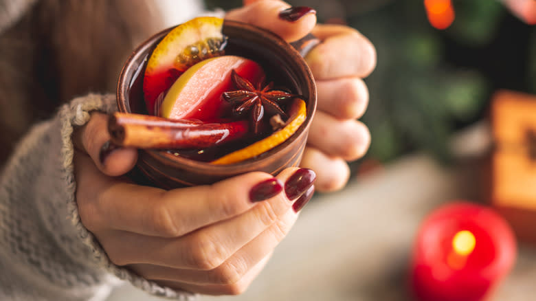 hands holding mulled wine