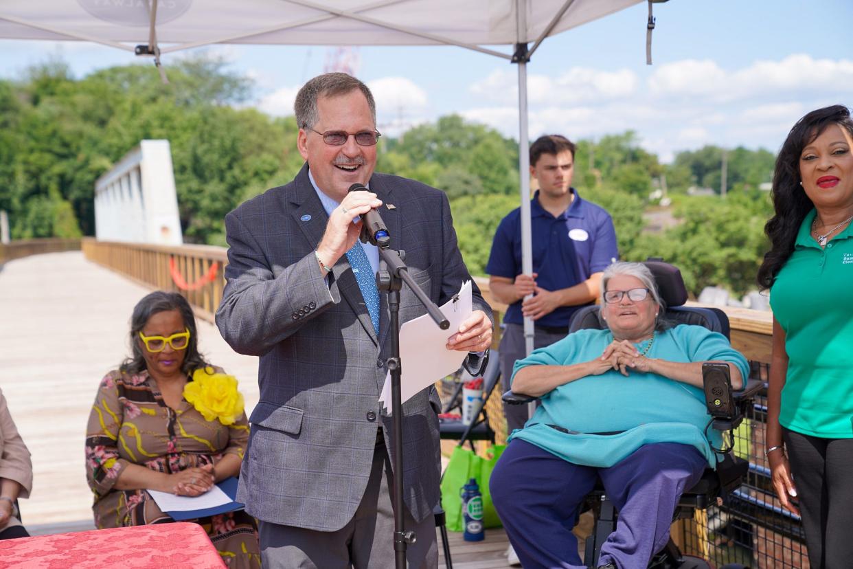 President and CEO of Ohio and Erie Canalway Coalition Dan Rice speaks Friday at the dedication of Phase I of the Rubber City Heritage Trail in Akron. Joining him from left are State Rep. Veronica Sims, D-AKron, Ward 10 Councilwoman Sharon Connor and Summit County Clerk of Courts Tavia Galonski.