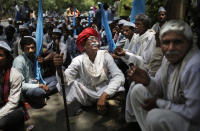 An elderly Indian villager, centre, smokes as he participates in a protest demonstration to highlight the water shortage across the country in New Delhi, India, May 5, 2016. Much of India is reeling under a heat wave and severe drought conditions that have decimated crops, killed livestock and left at least 330 million Indians without enough water for their daily needs. (Altaf Qadri/AP)
