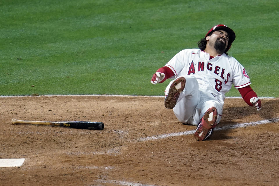 Los Angeles Angels' Anthony Rendon falls down after hitting a foul ball off his leg during the eighth inning of a baseball game against the Tampa Bay Rays Monday, May 3, 2021, in Anaheim, Calif. (AP Photo/Marcio Jose Sanchez)