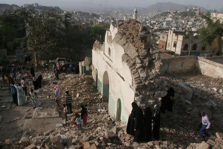 People gather among the rubble of a Sufi mosque that was blown up by explosive devices in an attack in the southwestern city of Taiz, Yemen, July 30, 2016. REUTERS/Anees Mahyoub