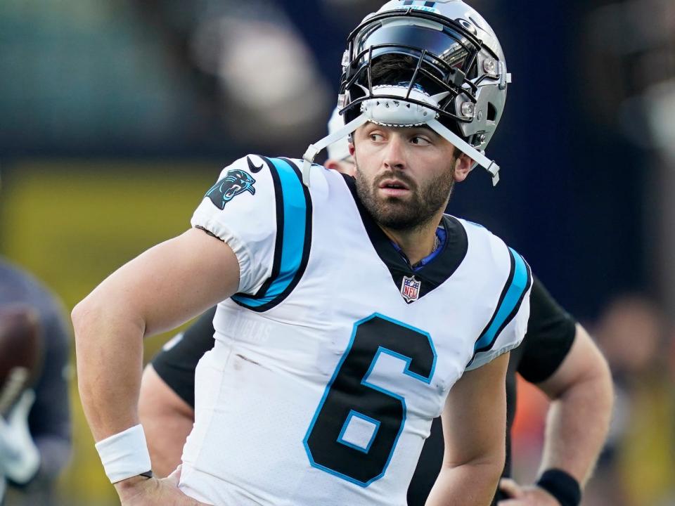 Baker Mayfield leans to his side while standing with his hands on his hips before a Panthers preseason game.