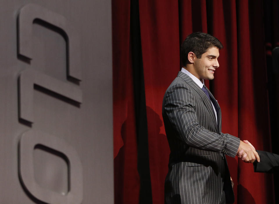 Eastern Illinois quarterback Jimmy Garoppolo is congratulated after being selected as the 62nd pick by the New England Patriots in the second round of the 2014 NFL Draft, Friday, May 9, 2014, in New York. (AP Photo/Jason DeCrow)