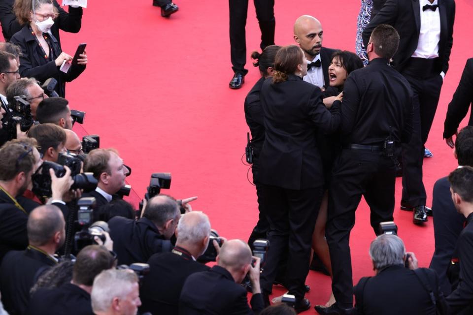 Security remove a protester from the red carpet at Cannes (Getty Images)