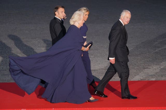 KCamilla dazzled in a midnight blue silk crepe dress and matching cape by Dior