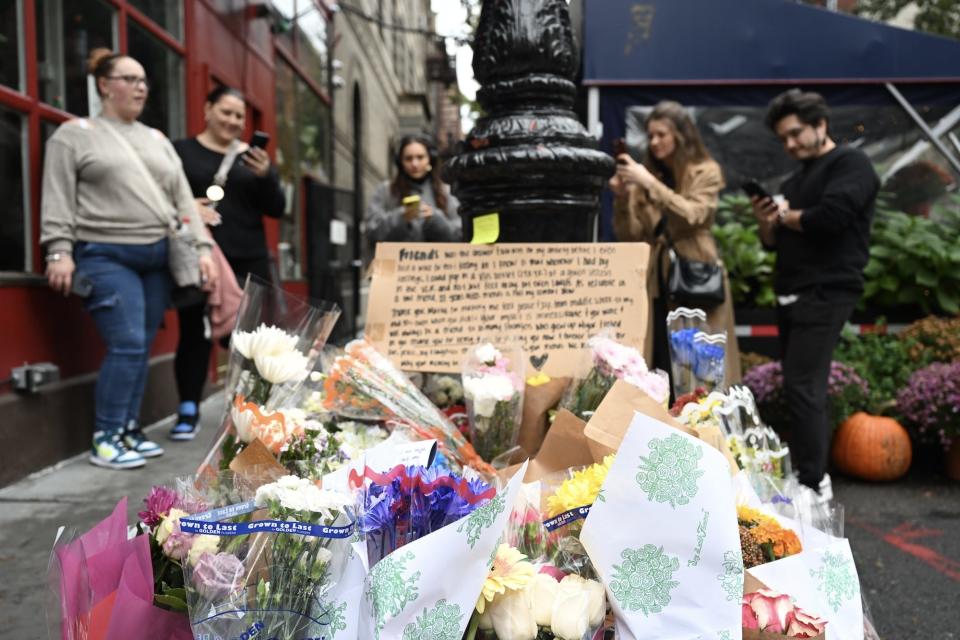 People place flowers in front of the building known as the 'Friends apartment' following the death of 54-year-old actor Matthew Perry, known for his role as 'Chandler Bing' in the TV series named 'Friends', in New York, United States on October 30, 2023.