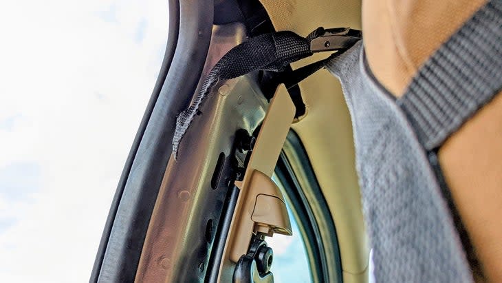 <span class="article__caption">Raingler’s mounting tabs interfered with the plastic trim that normally covers the Ranger’s B-pillar. So, the only option was to remove the top half of that trim entirely. It looks messy, but doesn’t impair the function of any equipment. </span>
