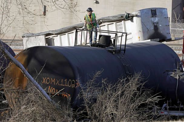 PHOTO: FILE - A cleanup worker stands on a derailed tank car of a Norfolk Southern freight train in East Palestine, Ohio, continues, Feb. 15, 2023. (Gene J. Puskar/AP, FILE)