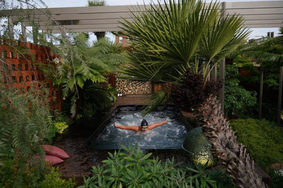 A woman uses a garden with a hot tub during the RHS Chelsea Flower Show press day at the Royal Hospital Chelsea, London (Yui Mok/PA) (PA Wire)