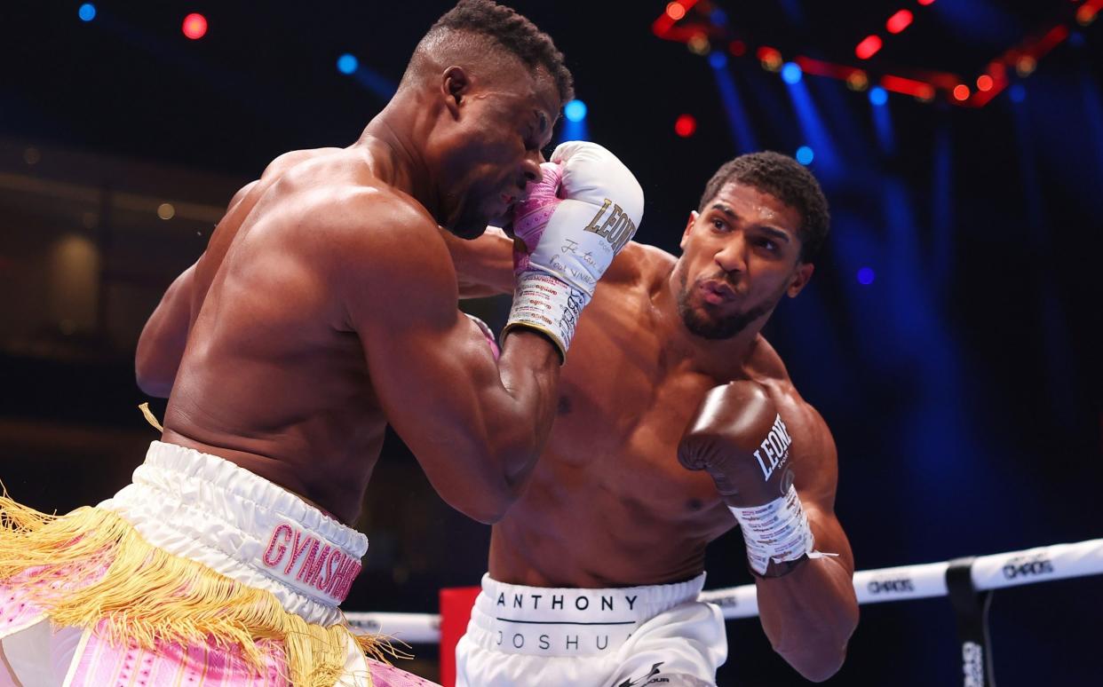 Anthony Joshua punches Francis Ngannou during the Heavyweight fight between Anthony Joshua and Francis Ngannou on the Knockout Chaos boxing card at the Kingdom Arena on March 08, 2024 in Riyadh, Saudi Arabia
