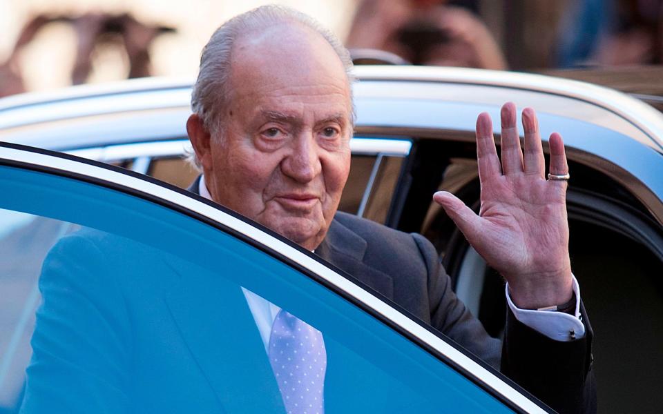 2018 Former King Juan Carlos I of Spain waves as he leaves after attending the traditional Easter Sunday Mass of Resurrection - AFP