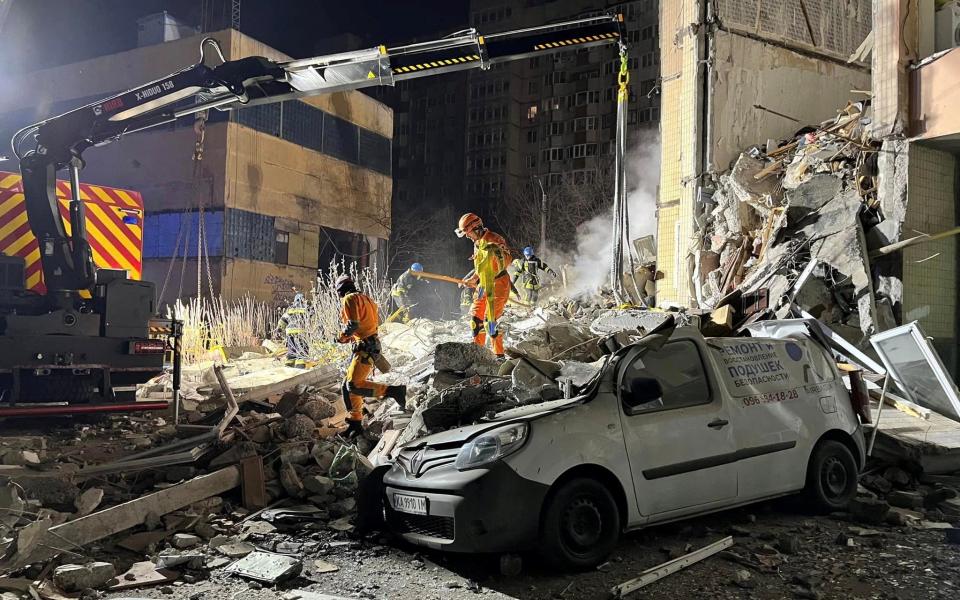 Rescuers at an apartment building heavily damaged by a Russian drone strike in Odesa