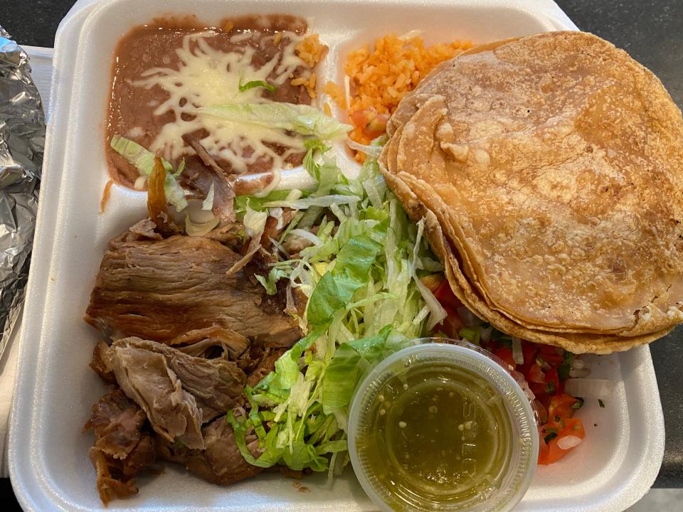 The carnitas plate from Fast Taco - pulled pork, served with corn tortillas, lettuce and tomatoes with beans and rice on the side.