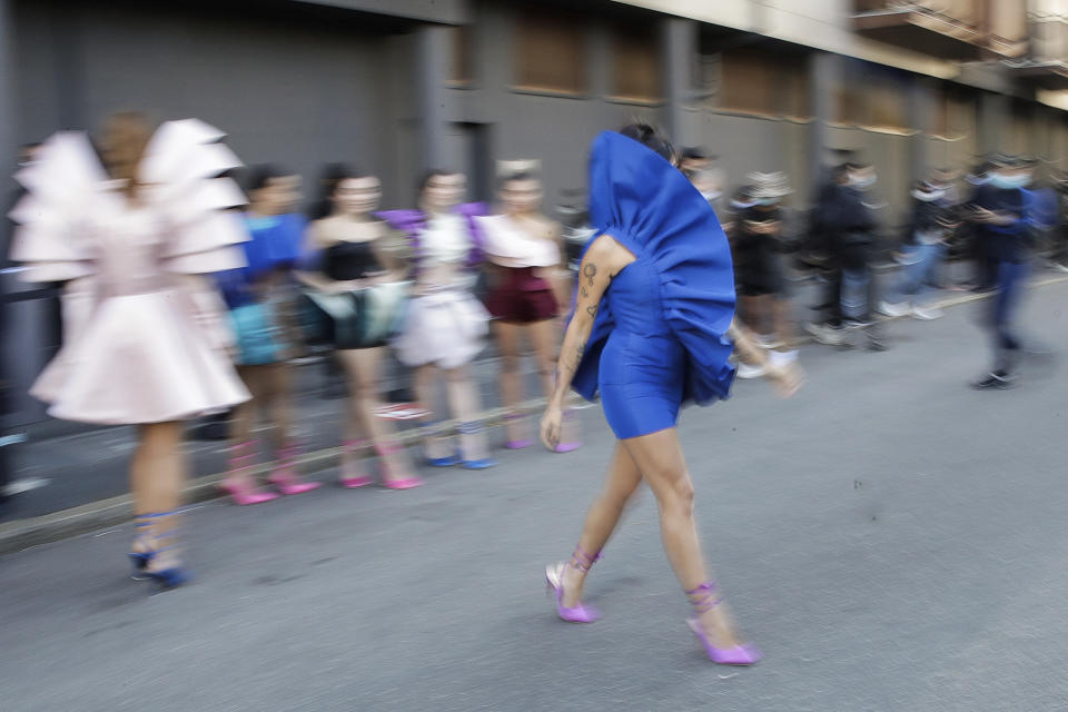 Fashion student Nora Bourelly shows her creation outside Valentino women's Spring-Summer 2021 fashion show location, in Milan, Italy, Sunday, Sept. 27, 2020. (AP Photo/Luca Bruno).