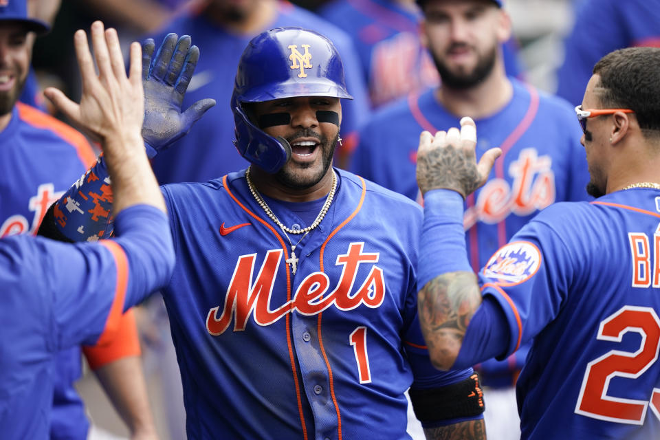 New York Mets' Jonathan Villar (1) celebrates in the dugout after his two-run home run scores Dominic Smith during the sixth inning of a baseball game against the Washington Nationals, Sunday, Aug. 29, 2021, in New York. (AP Photo/Corey Sipkin)