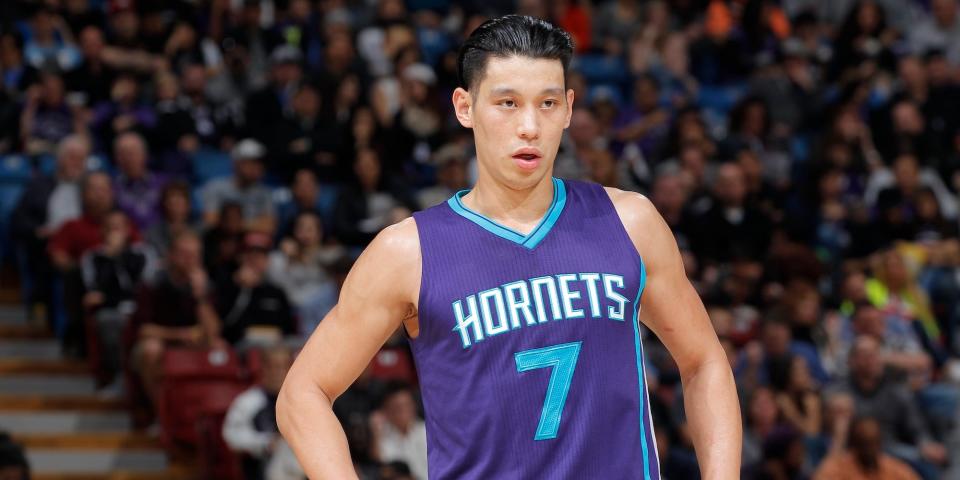 Jeremy Lin stands with his hands on his hips during a Hornets game in 2016.