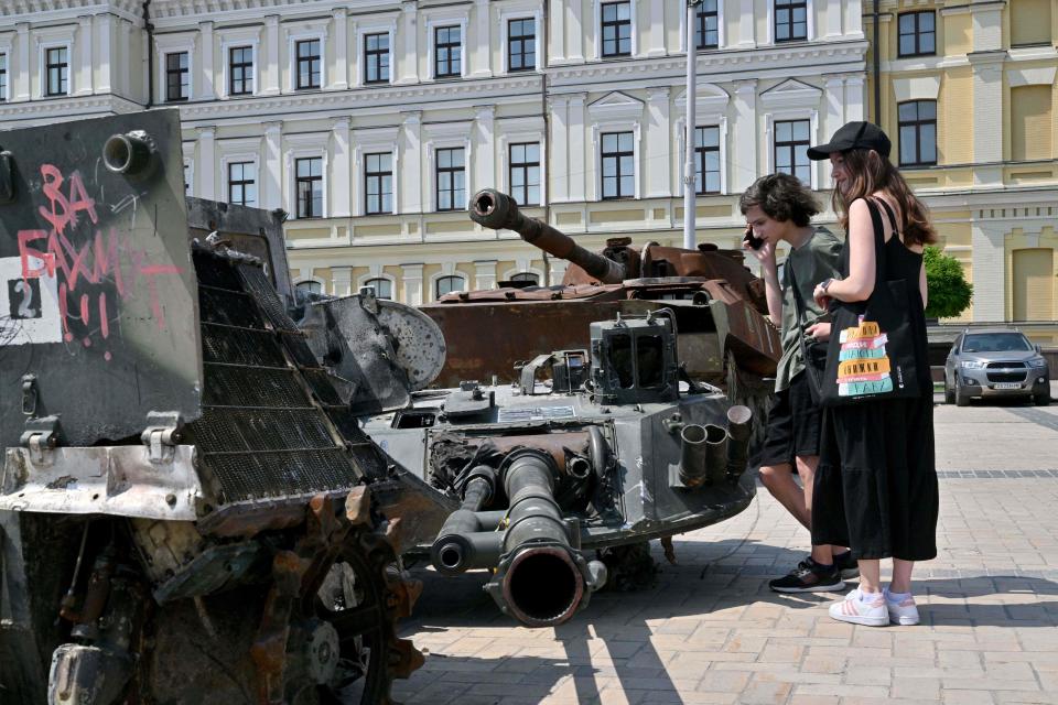 Children examine new items displayed at the open air exhibition of destroyed Russian armoured vehicles in Kyiv (AFP via Getty Images)
