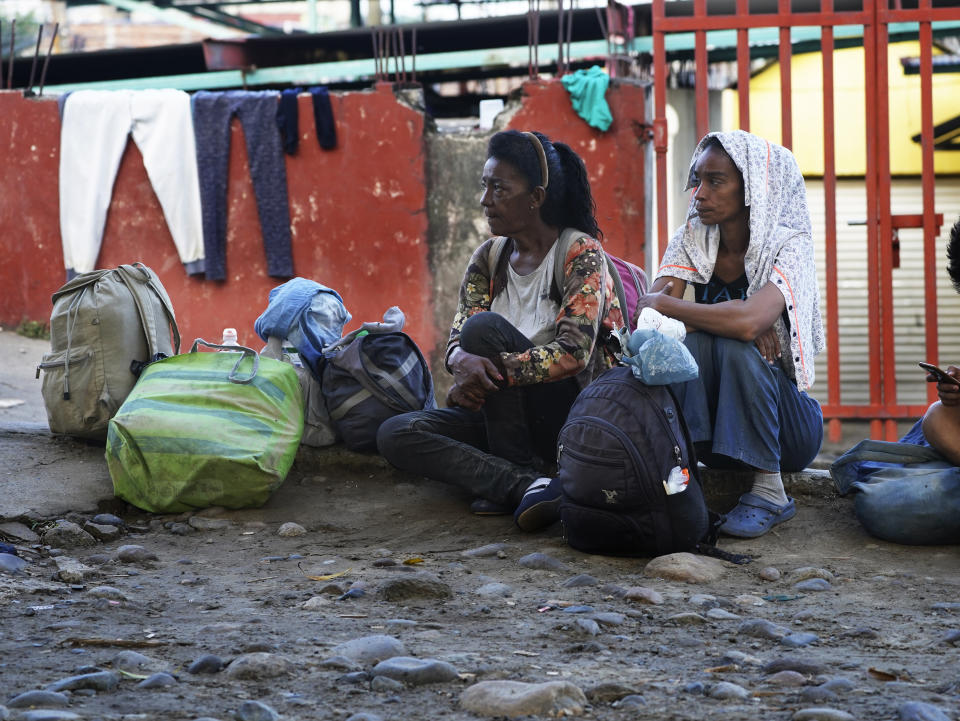 Migrants rest after crossing the Suchiate River, the border between Guatemala and Mexico, near Ciudad Hidalgo, Chiapas state, Mexico, Tuesday, Oct. 4, 2022. There is a booming business for legal immigration papers that preys on migrants who are largely poor, desperate and unable to turn elsewhere. (AP Photo/Marco Ugarte)