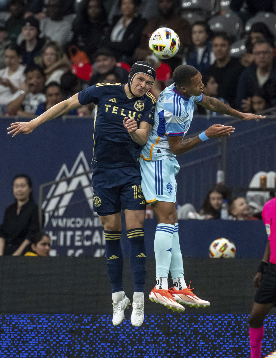 Vancouver Whitecaps' Bjorn Inge Utvik, left, and Colorado Rapids' Calvin Harris jump for a head ball during the second half of an MLS soccer match Saturday, June 1, 2024, in Vancouver, British Columbia. (Ethan Cairns/The Canadian Press via AP)