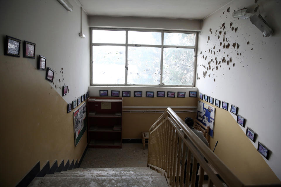 Bullet holes line the wall of the maternity hospital, after gunmen stormed the facility on May 12. | Rahmat Gul—AP