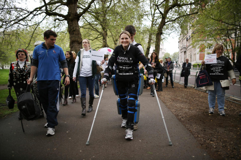 LONDON, ENGLAND - MAY 08: Claire Lomas (C) walks the last mile of the London Marathon on May 8, 2012 in London, England. Ms Lomas, who is paralysed from the waist down after a riding accident in 2007, has taken 16 days to complete the 26.2 mile route. Starting out with 36,000 other runners she has averaged 2 miles a day with the help of a bionic ReWalk suit. (Photo by Peter Macdiarmid/Getty Images)