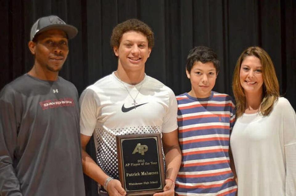 Patrick Mahomes holds his Texas Associated Press Sports Editors football player of the year award with his father, Pat, left, younger brother, Jackson, and mother, Randi, in Whitehouse, Texas. He was a three-sport star at Whitehouse High.