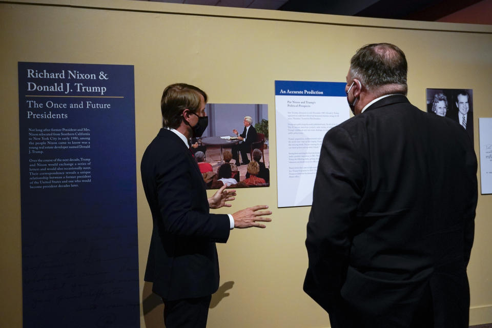 In this July 23, 2020, photo Secretary of State Mike Pompeo, right, tours an exhibit featuring letters written between Donald Trump and Richard Nixon at the Richard Nixon Presidential Library with Christopher Nixon Cox, left, grandson of former U.S. president Richard Nixon, in Yorba Linda, Calif. (AP Photo/Ashley Landis)