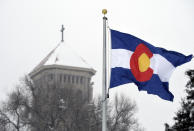 The Colorado state flag blows in the wind during a snowstorm at the Archdiocese of Denver campus on Wednesday, Jan. 18, 2023. The archdiocese is being sued by a man who alleges about 100 instances of abuse at St. Elizabeth Ann Seton Church in Fort Collins, Colo., from 1998 to 2003. The lawsuit is allowed under a 2021 state law that opened up a three-year window for people to pursue litigation for sexual abuse that happened to them as children dating as far back as 1960.(AP Photo/Thomas Peipert)