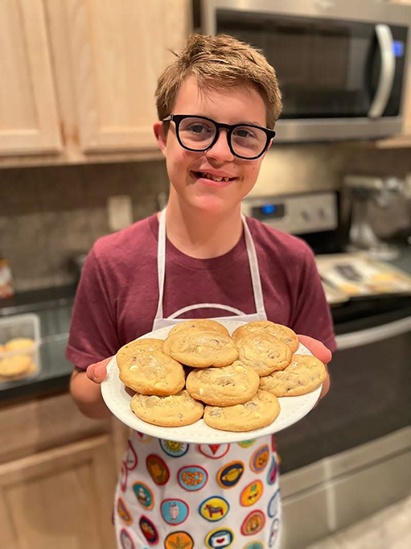 Caleb Prewitt, 16, shows off some of "Caleb's Cookies," a business he is developing with his family. The Jacksonville teen, who has Down syndrome, is an entrepreneur and a triathlete.