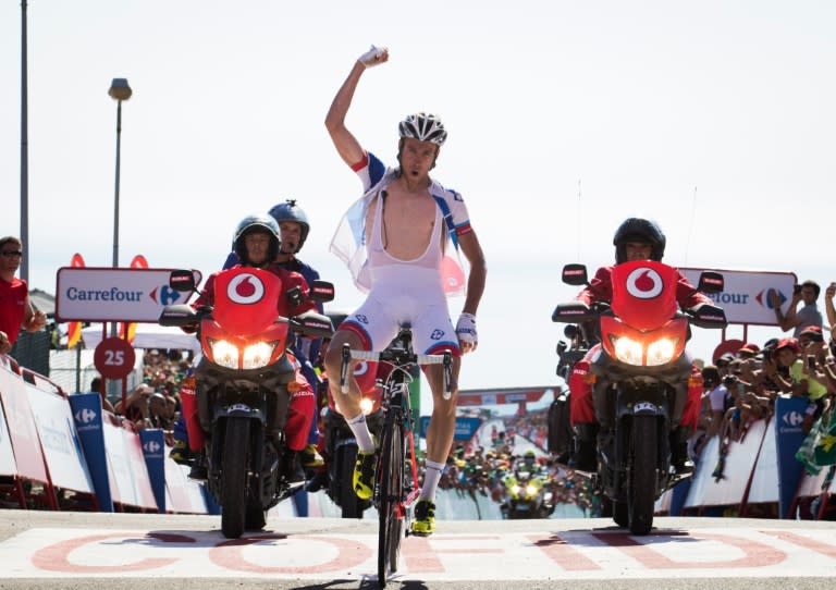 FDJ's French cyclist Alexandre Geniez celebrates winning as he crosses the finish line during the third stage of the 71st edition of "La Vuelta" Tour of Spain on August 22, 2016