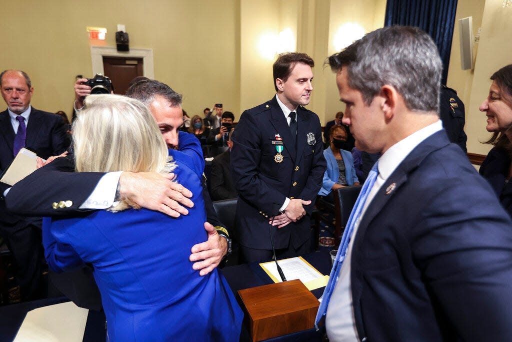 Rep. Liz Cheney, left, R-Wyo., hugs Washington Metropolitan Police Department officer Michael Fanone as he arrives to testify at the House select committee hearing on the Jan. 6 attack on Capitol Hill in Washington, Tuesday, July 27, 2021. (Oliver Contreras/The New York Times via AP, Pool)