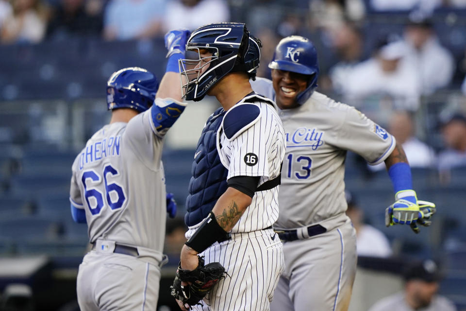 New York Yankees catcher Gary Sanchez, center, stares ahead as Kansas City Royals Ryan O'Hearn (66) and Salvador Perez (13) celebrate after O'Hearn hit a two-run, home run during the first inning of a baseball game, Wednesday, June 23, 2021, at Yankee Stadium in New York. (AP Photo/Kathy Willens)