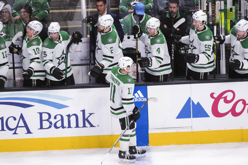 Dallas Stars center Logan Stankoven (11) is congratulated for a goal against the San Jose Sharks during the third period of an NHL hockey game Tuesday, March 5, 2024, in San Jose, Calif. (AP Photo/Nic Coury)