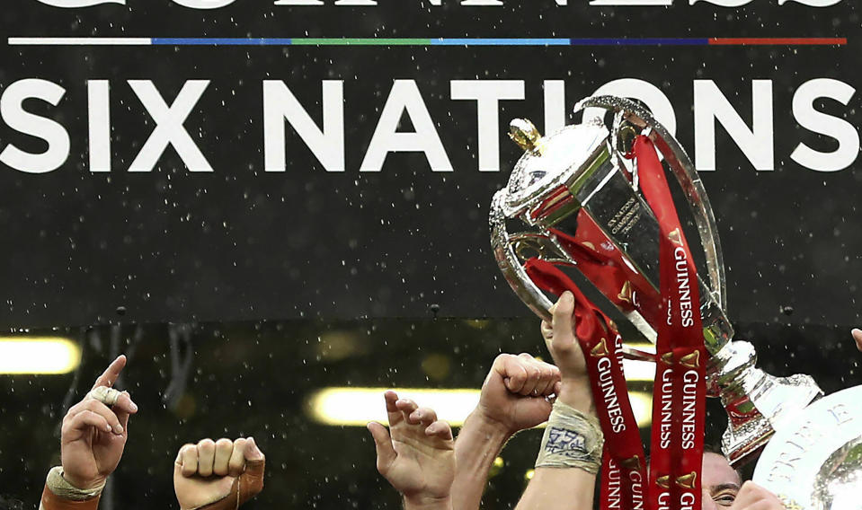 FILE - In this file photo dated Saturday, March 16, 2019, Wales rugby team celebrates with their trophies after winning the Six Nations championships, at the Millennium stadium in Cardiff, Wales. This year’s competition has yet to be completed after it was halted by the coronavirus pandemic but it is announced Wednesday June 3, 2020, that next season's Six Nations could be expanded to a home-and-away format under proposals being considered by the competing nations.(David Davies/FILE via AP)