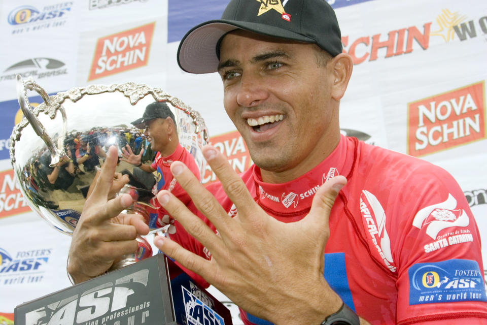 Kelly Slater (pictured) holds the trophy after winning the world title.