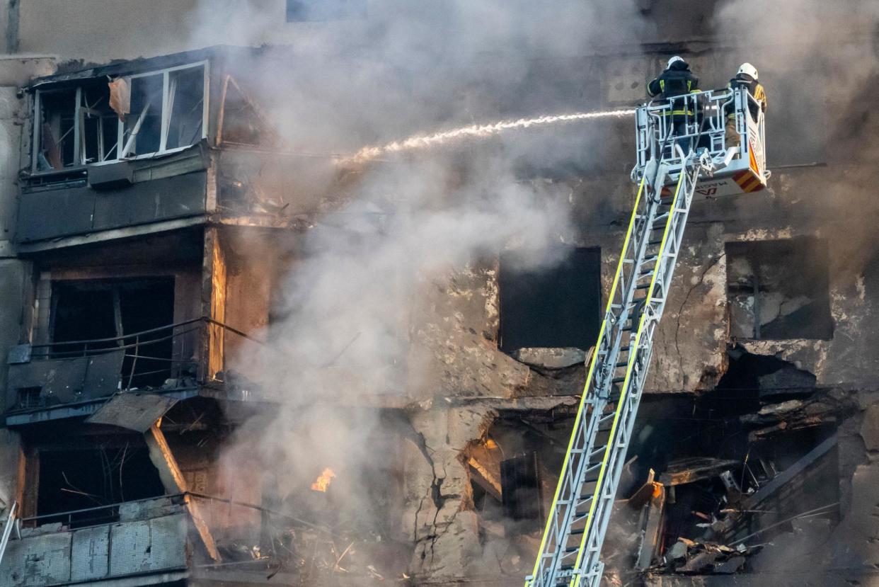 <span>Firefighters tackle a blaze after a Russian aerial bomb struck a multistorey residential building in Kharkiv, Ukraine, on Sunday.</span><span>Photograph: Andrii Marienko/AP</span>