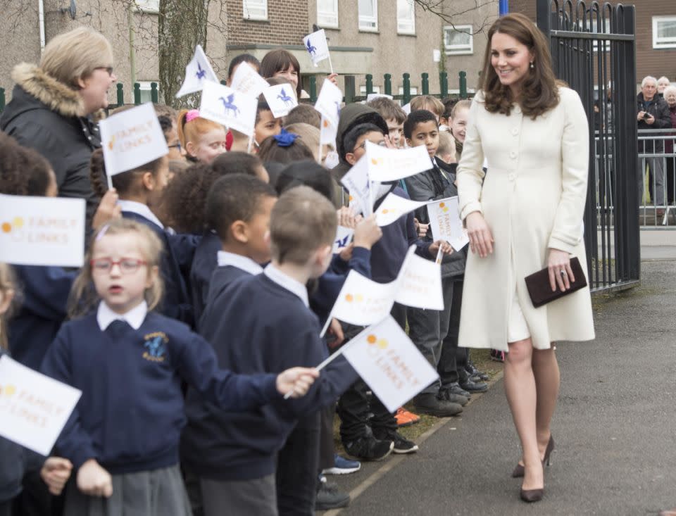 She was greeted at the school gates by a swarm of flag-bearing kids. Photo: Getty Images